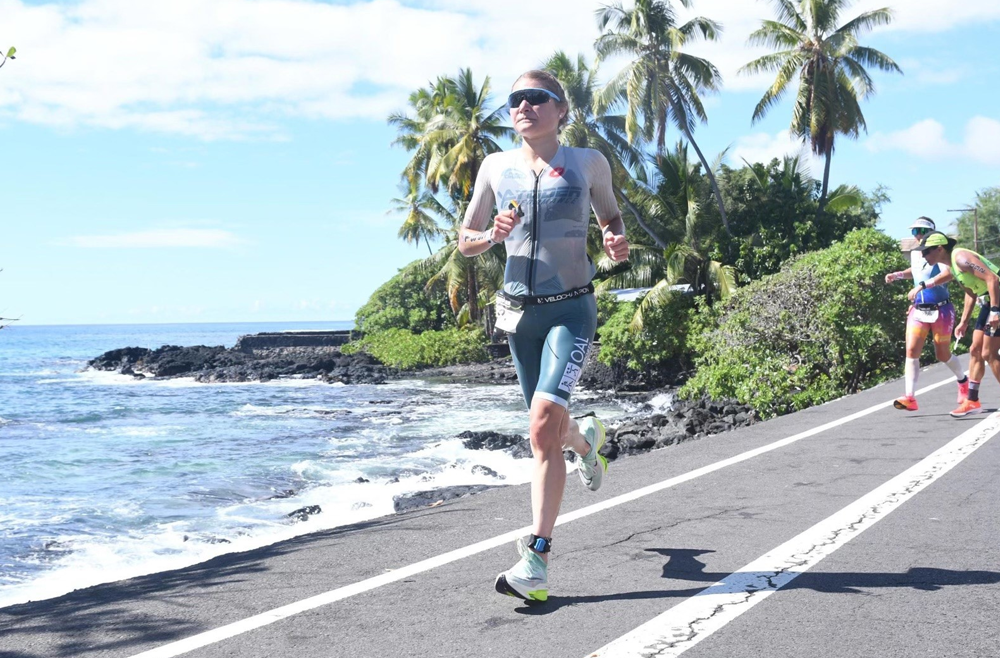 Warfel is shown running alongside the ocean in Hawai’i during the IRONMAN race.